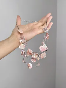 Close-up of pink iridescent multi-layer beaded necklace with adjustable lobster clasp