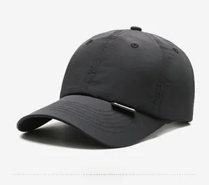Side view of black quick-dry baseball cap with micro-wrinkle texture and woven label