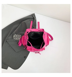 Detail view of rose red drawstring backpack with cross studs and spacious interior