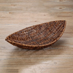 Close-up of boat-shaped woven food basket showing brown imitation rattan texture