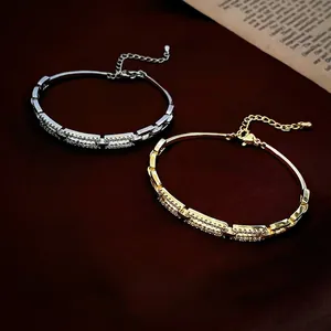 Gold and silver plated hollow square bangles with cubic zirconia on red velvet