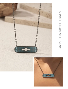 Detail of S925 silver star necklace with turquoise stone on black chain and model view