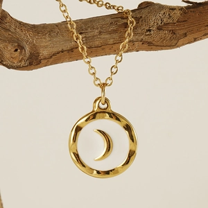 Minimalist gold moon pendant necklace with white enamel inlay and hammered metal texture