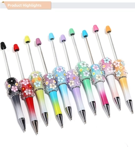 Close-up of DIY beaded ballpoint pens with gradient colors and floral charms set of 10