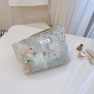 Floral canvas makeup bag with zipper and simple wish label in blue and pink tones
