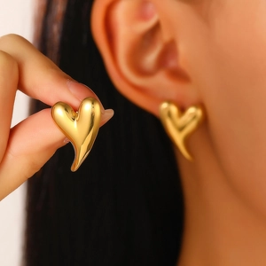 Detailed view of irregular 18K gold-plated heart earring with a polished mirror finish