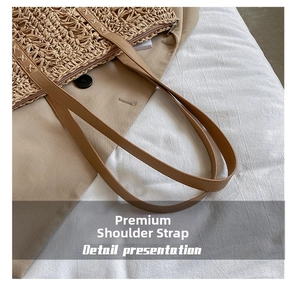 Close-up of woven straw tote bag with brown PU leather strap and sturdy cross-stitching