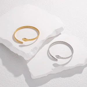 Detailed view of adjustable snake-shaped stainless steel bracelets in gold and silver