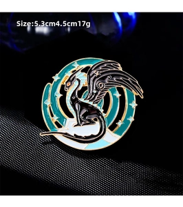 Detail showing the 5.3cm x 4.5cm size of the vintage enamel dragon brooch in green and gold