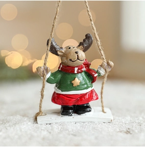 Close-up of a hand-painted resin reindeer ornament in festive attire with bokeh lighting