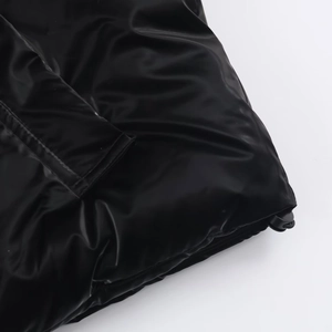 Close-up of shiny black waterproof fabric with adjustable drawstring on thick winter coat