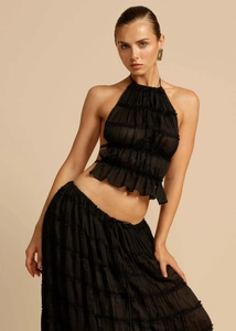 Detailed close-up of black ruffled halter top and layered maxi skirt set for women