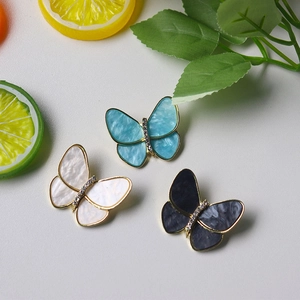 Elegant butterfly brooches with pearl and rhinestones in blue, white, and grey colors