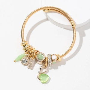 Golden stainless steel heart bracelet with green cat-eye stone and swan tassel pendant