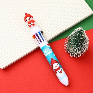 Detailed view of a 10-color Christmas ballpoint pen with 3D snowman on notebook