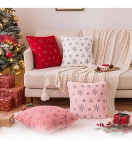 Detailed embroidery of colorful snowflakes on soft plush Christmas pillow cases in home setting