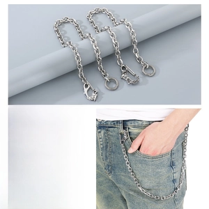 Macro detail of punk eagle head lobster clasp and silver O-chain on blue denim jeans