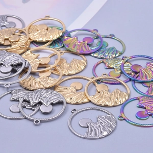 Macro shot of 304 stainless steel mountain and sun pendants for DIY jewelry making