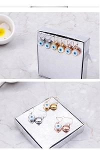 Détails des boucles d'oreilles œil porte-bonheur en argent, or et or rose
