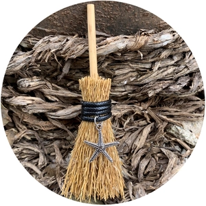 Miniature straw witch broom car pendant featuring a silver starfish charm and wood handle