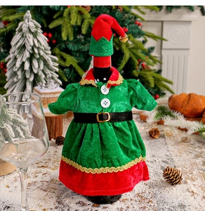 Detailed view of velvet elf wine bottle covers in festive red and green with gold belt detail