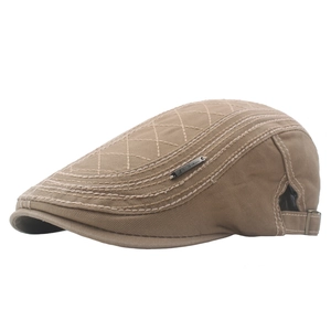 Khaki cotton flat cap with diamond quilting and side metal buckle on white background