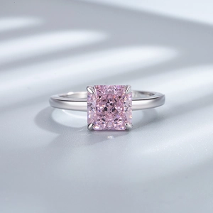 Detail of a pink square-cut gemstone ring with silver four-prong setting and macro finish