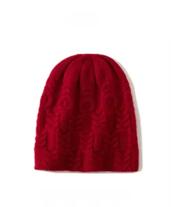 Detail of Pomegranate Red knit beanie showing 3D cable stitch pattern and soft texture