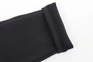Close-up of high-elastic black bodysuit fabric with premium reinforced stitching details