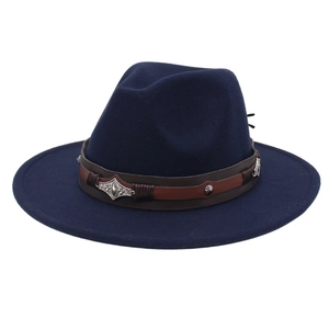 Detail of dark blue wool fedora featuring a brown leather band and silver metal hardware