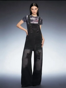 Vintage black ripped denim overalls for women with wide leg design and distressed details