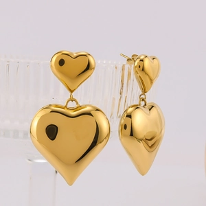 Polished 18k gold plated stainless steel double heart drop earrings on light background