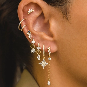 Elegant gold flower tassel earrings set with zircon stones on female model ear