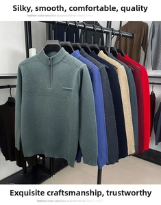 Detail showing various colors of men's half-zip knit sweaters hanging on a display rack