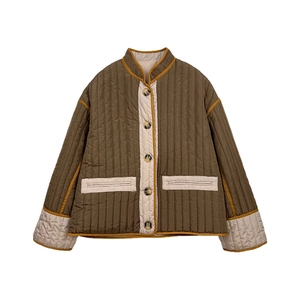 Detailed view of women's olive quilted jacket with cream contrast trim and dark buttons