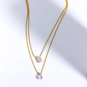 Detail view of 18K gold-plated double-layer necklace with oval and teardrop zircons