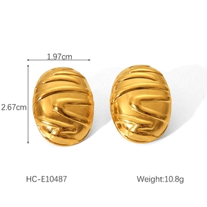 Detail of vintage geometric earrings showing irregular oval shape and wavy texture