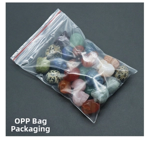 Detailed view of assorted natural crystal skull carvings in protective OPP bag packaging