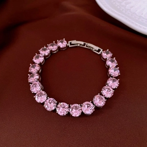 Close-up of pink zircon tennis bracelet on dark silk with elegant porcelain details