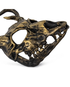 Detail of animal skull mask showing bronze gold metallic texture and bone carving details