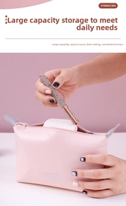 Pink PU storage bag with LOVE print showing interior capacity for makeup tools