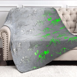 Detailed texture of grey flannel blanket with glow-in-the-dark dinosaur skeletons