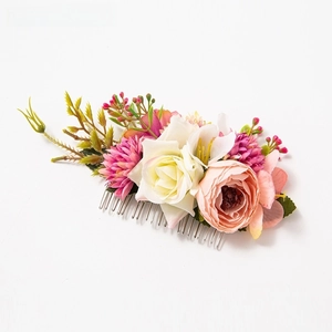 Detailed view of floral hair comb with silk roses, daisies, berries and metal teeth