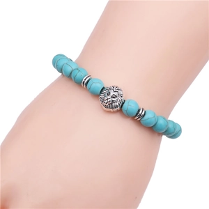 Close-up of beaded bracelet featuring blue-green natural stones and silver lion head