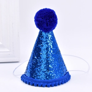 Detail showing blue glitter party hat with fluffy pompom and elastic strap for pets
