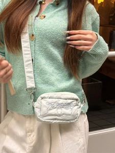 Quilted white nylon crossbody bag with light blue bow embroidery and wide shoulder strap
