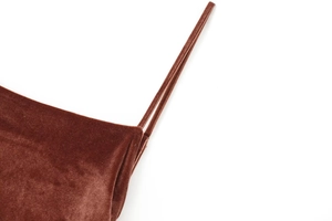 Close-up of dark brown velvet midi dress showing delicate straps and soft fabric texture