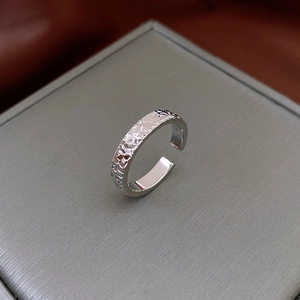 Macro shot of silver open ring with unique hammered texture and vintage French style finish