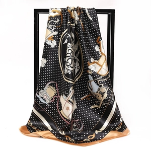 Retro black silk scarf detail featuring white polka dots and vintage carriage pattern