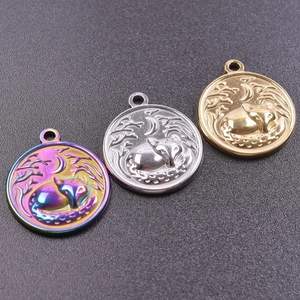 Detail of round fox and moon metal pendants in rainbow, gold, and silver finishes